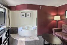 Traverse Blossom hotel King Two Room Whirlpool, couch, coffee table, and TV