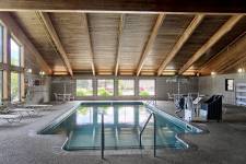 Traverse Blossom pool room with lounge chairs, table and chair sets