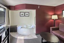 Traverse Blossom hotel King Two Room Whirlpool, couch, coffee table, and TV
